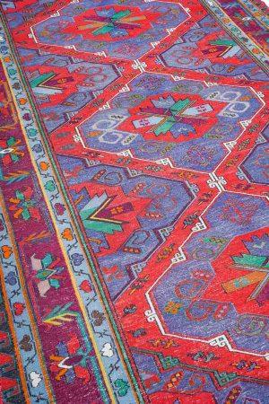 Rustic red and blue patterns on a vintage kilim rug by Carpet Cellar