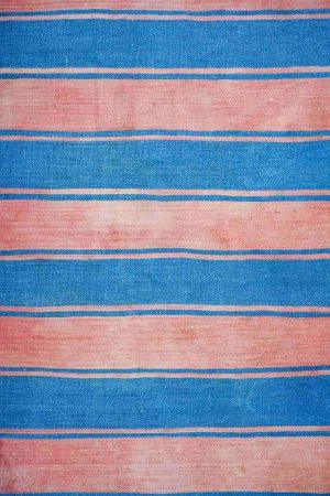 Dark blue and pink stripes on a cotton flatweave rug by Carpet Cellar