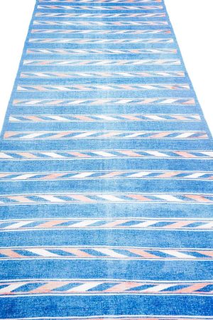Linear geometric patterns in cobalt blue and light pink on a kilim rug by Carpet Cellar