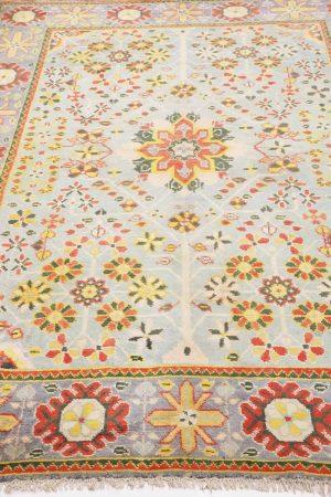 Rustic red patterns on a light blue antique Persian carpet by Carpet Cellar