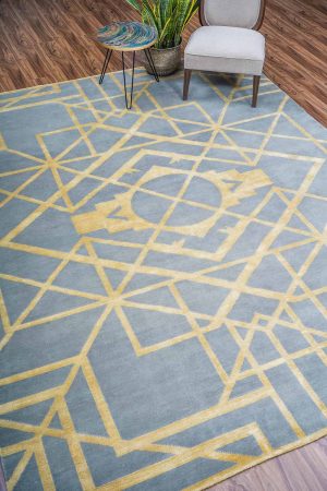 Gold geometric patterns on a blue grey modern carpet by Carpet Cellar