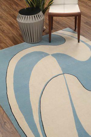 Minimalist modern carpet with blue and beige abstract swirls by Carpet Cellar