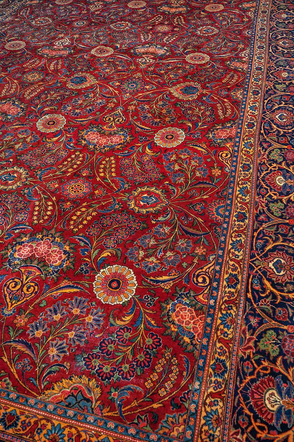 Red carpet for bedroom with intricate floral designs by Carpet Cellar